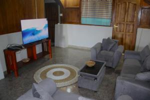 a living room with couches and a flat screen tv at Lakey Peak Haven in Huu