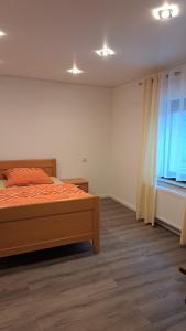 a bedroom with a bed and a window at Haus Linde in Wengenroth