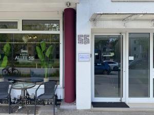a store with a table and chairs in front of a window at Hotel Allee 55 in Hannover