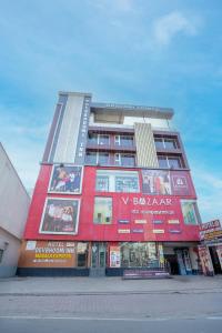 a tall building with advertisements on the side of it at Devbhoomi Inn in Deoghar