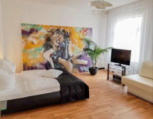 a bedroom with a large painting on the wall at City Urlaub in Ribnitz-Damgarten