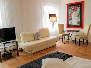 a living room with a couch and a table at City Urlaub in Ribnitz-Damgarten
