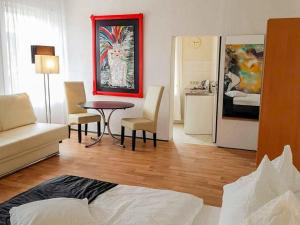 a living room with a couch and a table and chairs at City Urlaub in Ribnitz-Damgarten