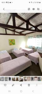 a room with three beds in a room at Pousada Icaraí Inn in Niterói