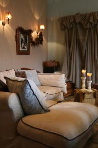 a living room with a couch and two candles at La Maison de Jeanne in Thiézac