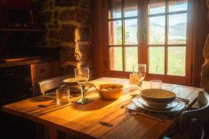 a wooden table with plates and glasses on it at Mullach Dearg in Tarbert