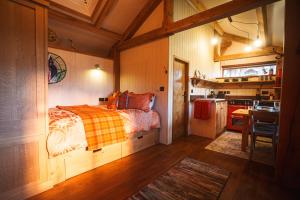 a bedroom with a bed and a small kitchen at Mullach Dearg in Tarbert +14 photos