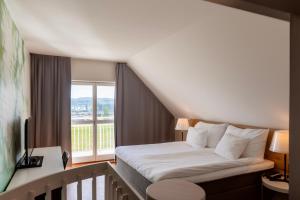 a hotel room with a bed and a window at Selma Spa in Sunne +40 photos