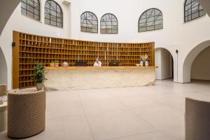 a large lobby with a reception desk in a building at Malia Bay Beach Hotel & Bungalows in Malia +148 photos