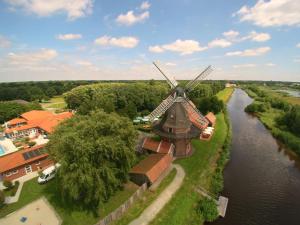 an aerial view of a windmill next to a river at Landhaus Baumhöfer in Apen