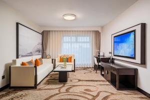 a living room with a couch and a tv at Beijing Landmark Hotel in Beijing +76 photos