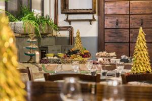 a table with christmas food and trees on it at La Canonica dei Fiori - Anna Fendi Country House in Ronciglione +23 photos