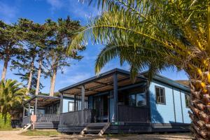 a house on the beach with palm trees at Camping RCN Port l'Epine in Trélévern