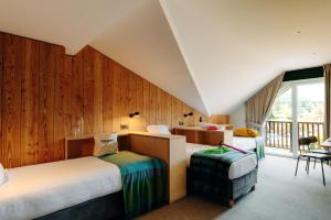 a bedroom with two beds and a balcony at PlanB Hotel - Living Chamonix in Chamonix +76 photos