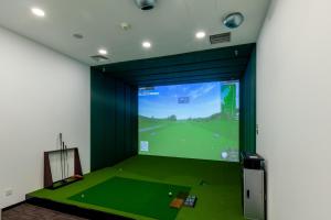 a room with a golf course on the screen at Beijing Landmark Hotel in Beijing