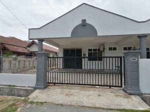 a house with a gate and a fence at Promenade Homestay 2 in Kampong Sura Masjid