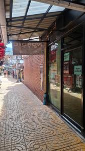 an empty building with a brick wall and a sidewalk at Nordic Hostel I Female Only I Dorms only in Phi Phi Islands