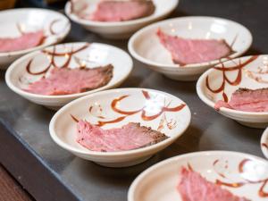 a bunch of white bowls of food on a table at APA Hotel Sugamo Ekimae in Tokyo +119 photos