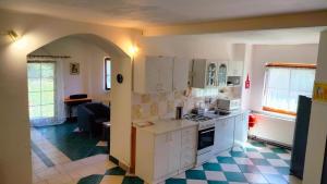 a kitchen with white cabinets and a stove top oven at Andels apartments Vila 3 in Rynholec