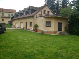 a house with a green lawn in front of it at Andels apartments Vila 3 in Rynholec