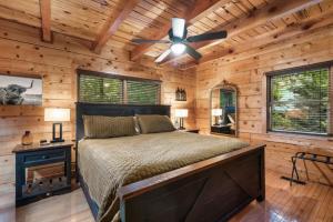 a bedroom with a bed and a ceiling fan at Awesome Adventures By Avada Properties in Sevierville +48 photos