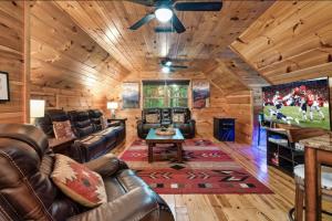 a living room with leather couches and a tv at Awesome Adventures By Avada Properties in Sevierville