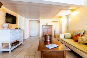 a living room with a couch and a coffee table at Mas des Oliviers in Redortiers