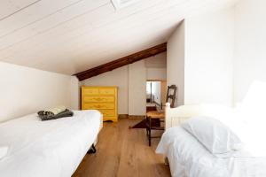 an attic bedroom with two beds and a yellow dresser at La Ferme D'estafinette in Redortiers +36 photos