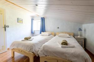 a bedroom with two beds and a window at Mas des Oliviers in Redortiers +36 photos