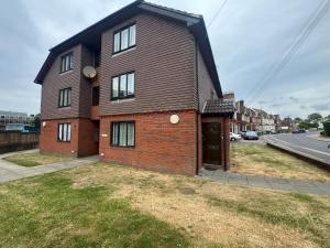 a brown brick house on the side of a street at Princess House in Redhill