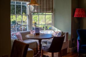 a living room with a table and a couch at Diglis House Hotel in Worcester