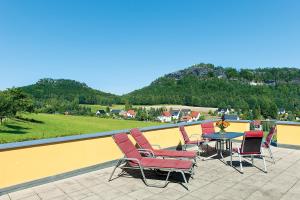 a group of chairs and a table on a roof at Alter Gutshof Papstdorf in Papstdorf