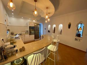 a kitchen with a large island in a room at Dar hayat in Djerba