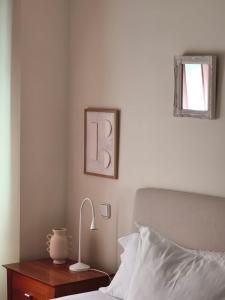 a bedroom with a bed and a table with a lamp at LA ERMITA in Zamora