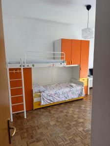 a bedroom with a bunk bed and orange cabinets at Via degli Dei house in Sasso Marconi