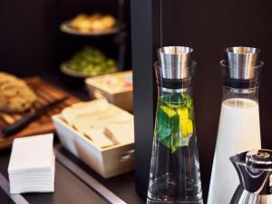 a vase with fruit in it sitting on a table at B&B HOTEL Memmingen in Memmingen +29 photos