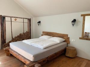 a bedroom with a bed made out of logs at Vamiš in Gornji Petrovci