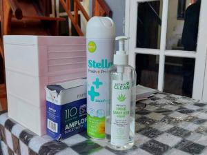 a couple of bottles of cleaning products sitting on a table at Quattrick Dee Homestay Mitra RedDoorz in Manokwari