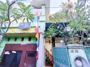 a building with a door and a sign on it at Quattrick Dee Homestay Mitra RedDoorz in Manokwari