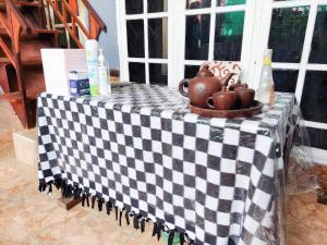 a table with a black and white checkered table cloth at Quattrick Dee Homestay Mitra RedDoorz in Manokwari
