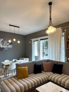 a living room with a couch and a table at White Sand Apartment Valamar 2 Bedroom Balcony Parking in Draç