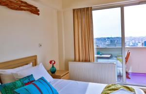a bedroom with a bed and a large window at Han Hotel Istanbul in Istanbul