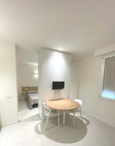 a small room with a table and a bed at Appartamenti Angelo e Maria in Lovere