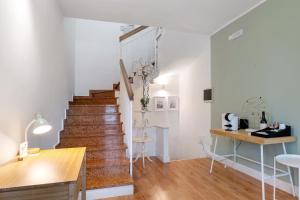 a staircase in a room with white walls and wooden floors at Bc Garda House in Peschiera del Garda
