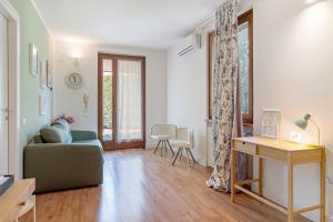 a living room with a couch and a table at Bc Garda House in Peschiera del Garda +50 photos