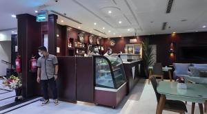 a man standing in front of a restaurant at فندق ان فيولا in Jazan
