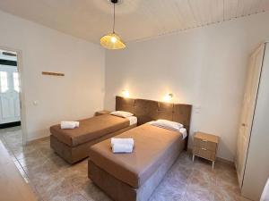 two beds in a room with two brown beds at Villa Delphini in Argyrátika +33 photos
