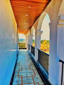 a porch of a building with a wooden ceiling at Geetanjali hotel and resort in Udaipur