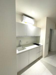 a kitchen with white cabinets and a sink at Appartamenti Angelo e Maria in Lovere +14 photos