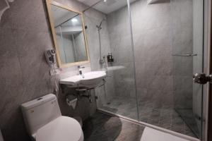a bathroom with a shower and a toilet and a sink at Happy Inn in Taichung